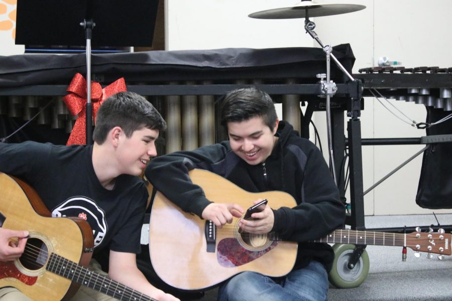 Students+in+the+guitar+class+practicing+in+the+band+room.+Guitar+has+relocated+from+their+portable+to+the+band+room+and+cafeteria.+