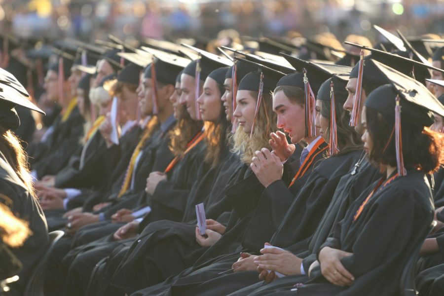 Students+at+last+year%E2%80%99s+graduation.+Changes+in+guidelines+for+graduation+attire+this+year+will+allow+students+in+club+and+elective+programs+to+wear+pre-approved+memorabilia.+